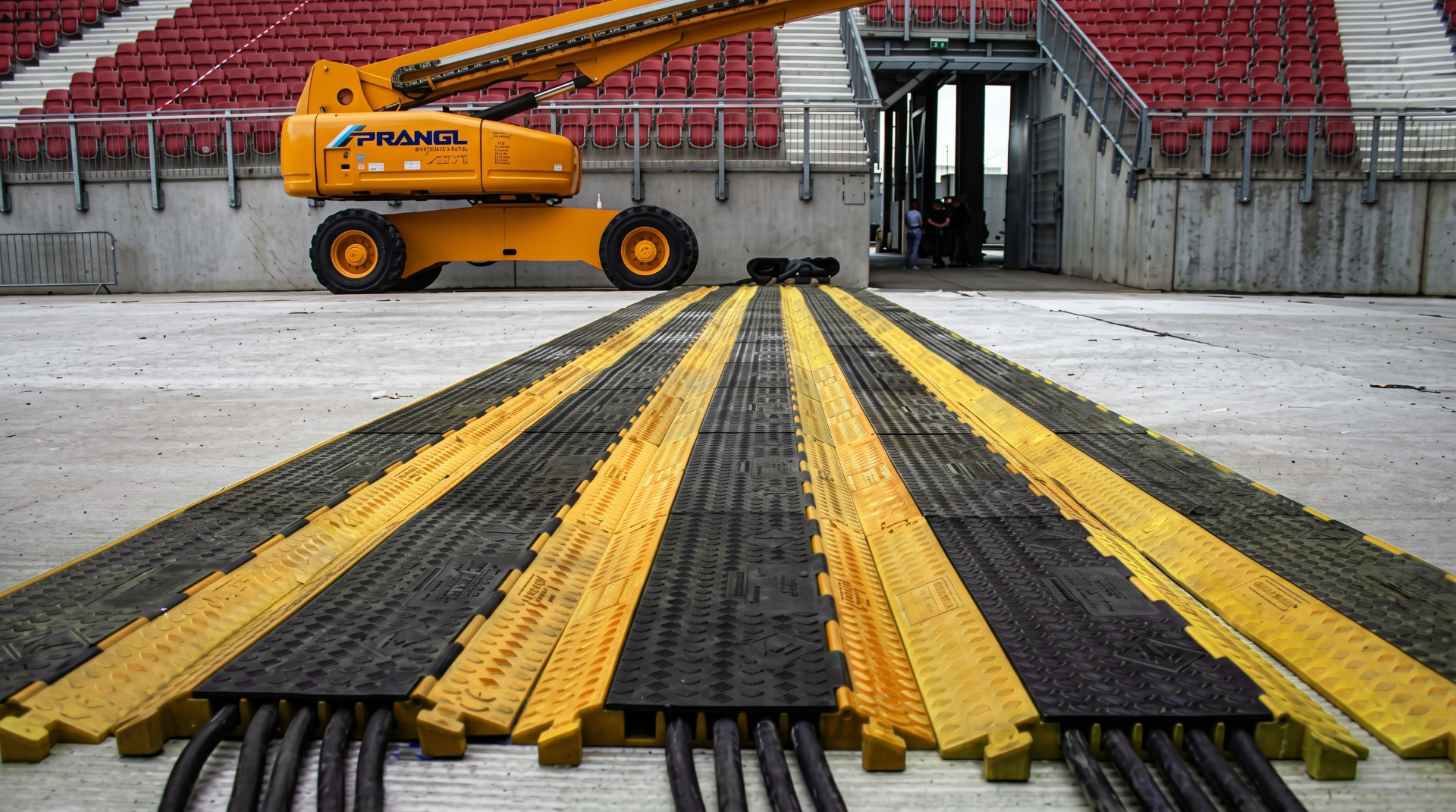 Cable ramps laid across a stadium floor
